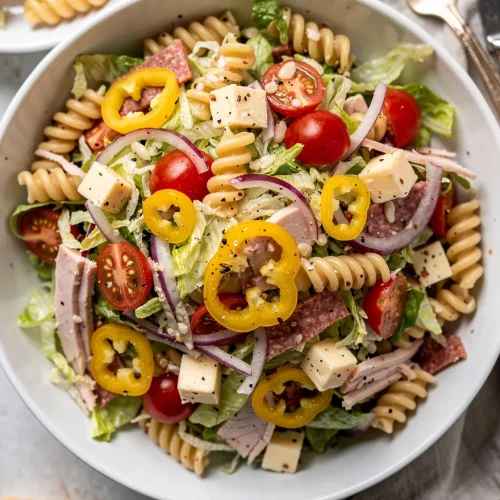 Grinder pasta salad with rotini, salami, cheese cubes, and vegetables