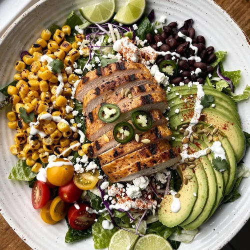 High Protein Chicken Street Corn Salad with grilled chicken, avocado, roasted corn, black beans, cherry tomatoes, cotija cheese, and creamy lime dressing.